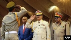 Le maréchal Khalifa Haftar, au centre, salue le chef d'état-major de l'armée nationale libyenne l'ancien Premier ministre libyen Abdullah al-Thani, le 7 mai 2018 à Benghazi, (AFP PHOTO / Abdullah DOMA)