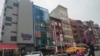 A six story glass facade building, pictured second from left in New York's Chinatown, April 17, 2023, is believed to be the site of a foreign police outpost for China.