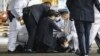 A suspect is caught by police after he allegedly threw an object, as Japanese Prime Minister Fumio Kishida visited a campaign event in Wakayama, Japan, April 15, 2023.