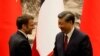 China's President Xi Jinping (R) shakes hands with his French counterpart Emmanuel Macron after the signing ceremony in Beijing on Apr. 6, 2023. 
