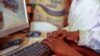 FILE - Two boys use a computer in Nairobi, Kenya, Sept. 29, 2021. Experts in digital technology and communications said on May 7, 2024, that African nations should pass laws to better protect the flow of data across borders while protecting people's privacy and safety.