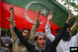 Pakistan Tehreek-e-Insaf (PTI) party activists and supporters of Pakistan's former Prime Minister Imran Khan celebrate after Supreme Court declared Khan's arrest "invalid", in Lahore, Pakistan, May 11, 2023.