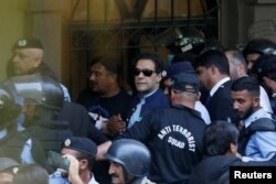 Security officers escort Pakistan's former Prime Minister Imran Khan, as he appeared in Islamabad High Court, Islamabad, Pakistan May 12, 2023.
