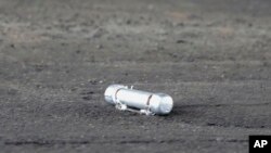 A suspicious object is seen on the ground where a suspect was arrested before Japanese Prime Minister Fumio Kishida was to begin his speech, in Wakayama, Japan, April 15, 2023.