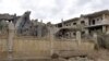 Jengo lililoharibiwa na shambulizi la anga katika mji wa kusini mwa Syria wa Deir Ezzor, Machi 26, 2024. Picha ya AFP