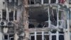 Police inspect an apartment building damaged by a drone, that was shot down during a Russian overnight strike, in Kyiv, Ukraine, Monday, May 8, 2023. 