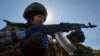 A Ukrainian service member is seen in a trench at a position on a front line, as Russia's attack on Ukraine continues, near the city of Bakhmut, Ukraine April 10, 2023.