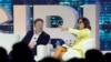 FILE - Twitter CEO Elon Musk, center, speaks with Linda Yaccarino, then the chairman of global advertising and partnerships for NBC, at a conference in Miami Beach, Florida, April 18, 2023.