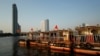 FILE - The Bangkok skyline is seen behind tourist boats on the Chao Phraya river in downtown Bangkok, Thailand, Feb. 4, 2021.