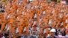 FILE - In this file photo taken on February 28, 2021 protesters hold posters with the image of detained civilian leader Aung San Suu Kyi during a demonstration against the military coup in Naypyidaw, Myanmar.