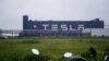 FILE - Tesla signage is seen at its factory in Shanghai, China, May 13, 2021.