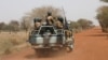 ARCHIVES - Des soldats burkinabè patrouillent sur la route de Gorgadji dans la région du Sahel, au Burkina Faso, le 3 mars 2019.