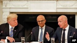 Le président Donald Trump, à gauche, et Satya Nadella, chef de la direction de Microsoft, écoutent Jeff Bezos, chef de la direction d'Amazon, lors d'une table ronde du American Technology Council à la Maison-Blanche, Washington, 19 juin 2017. 