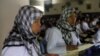 A Indonesian migrant worker heading for Middle East countries holds her passport documents at an immigration office. 