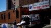Paramedics wheel a patient from an ambulance to an emergency arrival area at Elmhurst Hospital during the outbreak of the coronavirus disease (COVID-19) in the Queens borough of New York City, New York, April 6, 2020. 
