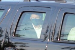 FILE - President Donald Trump drives past supporters gathered outside Walter Reed National Military Medical Center in Bethesda, Md., Oct. 4, 2020.