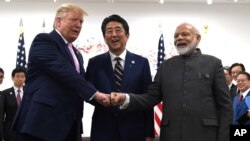 President Donald Trump, Japanese Prime Minister Shinzo Abe and Indian Prime Minister Narendra Modi share a fist bump during their meeting on the sidelines of the G-20 summit in Osaka, Japan, Friday, June 28, 2019. (AP Photo/Susan Walsh)