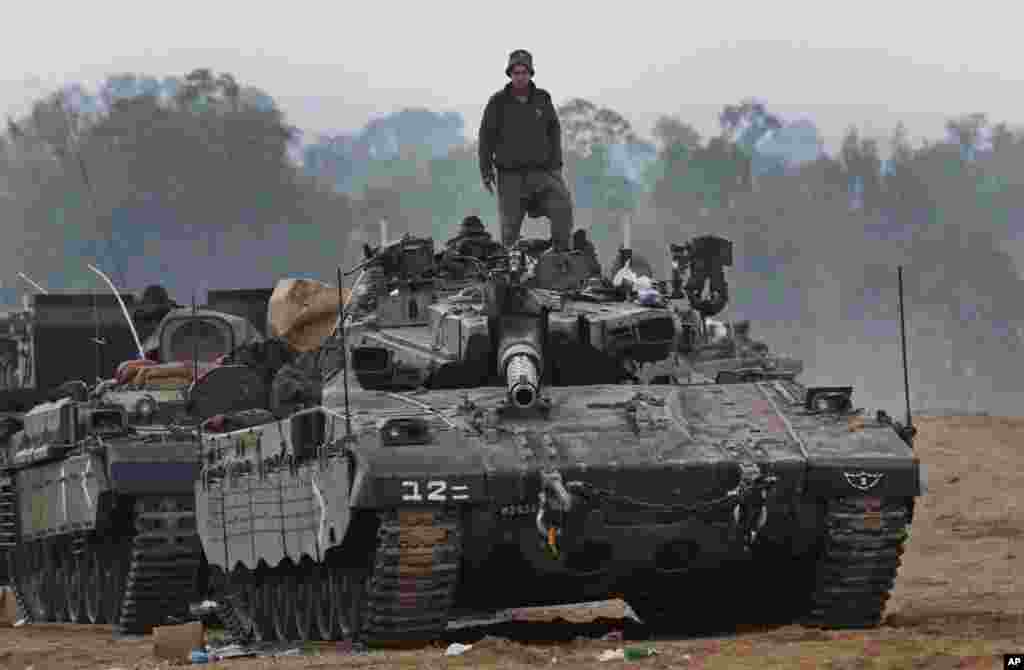 An Israeli soldier stands on a tank at a staging area near the Israel-Gaza Strip Border, November 20, 2012. 