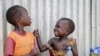 FILE - Children play outside a community center at an internally displaced person's camp, in the capital Juba, South Sudan, April 2, 2019.