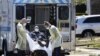 Emergency Medical Technicians lift a patient that was identified to have coronavirus disease into an ambulance while wearing protective gear, in New York City, New York, March 26, 2020.