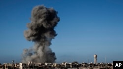 FILE - Smoke rises after an airstrike in Sirte, Libya, Sept. 28, 2016. The country's health ministry said Monday that an airstrike in Tripoli killed four children.