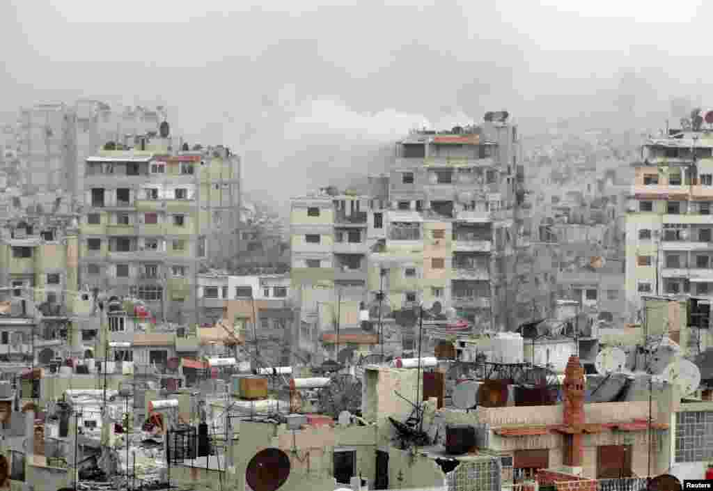 Smoke rises after shelling by forces loyal to Syria's President Bashar al-Assad in the old city of Homs March 22, 2013. 