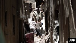 Wananchi wa Yemen wakipekua kifusi cha nyumba iliyoanguka baada ya madai kuwa majeshi ya Saudia na washirika wake kufanya mashambulizi ya anga katika mji mkuu wa Yemeni Sanaa, Mei 16, 2019.