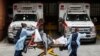 Patients are brought into Wyckoff Heights Medical Center by staff wearing personal protective gear due to COVID-19 concerns, April 7, 2020, in the Brooklyn borough of New York. 