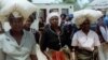 FILE: Unidentified rural women in Seke, Zimbabwe, 120 kilometres east of Harare, carry bags of donated maize from a food distribution point on Monday, Oct. 7, 2002. Seke is just one of many food distribution centers throughout Zimbabwe, which have been se
