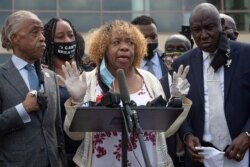 FILE - Gwen Carr, the mother of Eric Garner, addresses media at the public viewing of George Floyd, in Houston, Texas, June 8, 2020. Standing on the left is the Reverend Al Sharpton and on the right is attorney Ben Crump.