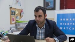 Omar Shakir, the local director of Human Rights Watch, works at his office in the West Bank city of Ramallah, Nov. 5, 2019.