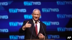 Blue and White party leader Benny Gantz addressees his supporters at party headquarters after the first results of the elections in Tel Aviv, Israel, Sept. 18, 2019.