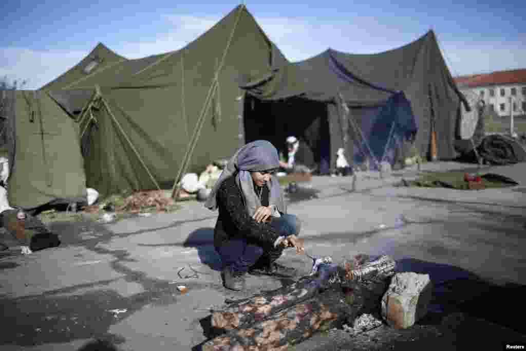 A Syrian girl prepares a fire in front of tents at a refugee camp in Harmanli, 280 km (173 miles) east of Sofia, December 9, 2013. REUTERS/Pierre Marsaut