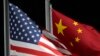 FILE - The American and Chinese flags wave at Genting Snow Park ahead of the 2022 Winter Olympics, in Zhangjiakou, Feb. 2, 2022. The Chinese government placed sanctions on seven companies on Friday in response to recent US announcements of military sales and aid to Taiwan