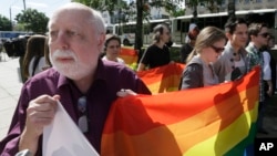 Un homme tient un drapeau lors de la première gay pride de l'Ukraine à Kiev, le 25 mai 2013. 