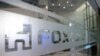 FILE - A sign of Foxconn is seen at a glass door inside its office building in Taipei, Taiwan Nov. 12, 2020.