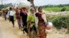 FILE - Rohingya refugees, who crossed the border from Myanmar two days earlier, walk after they received permission from the Bangladesh army to continue their way to Kutupalong refugee camp, near Cox's Bazar, Bangladesh, Oct. 19, 2017.