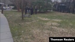Police officers detain a man near the official residence of US Vice President Kamala Harris on the grounds of the Naval Observatory in Washington, DC, March 17, 2021, in this still image taken a social media video. (@penguinsix/via Reuters)