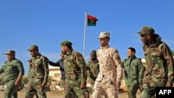 Fighters of a military battalion loyal to Libyan General Khalifa Haftar march during the morning assembly in the eastern city of Benghazi on Dec. 18, 2019. 