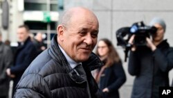 FILE - French Foreign Minister Jean-Yves Le Drian speaks with journalists as he arrives for a meeting to discuss the situation in Libya at the EEAS building in Brussels, Jan. 7, 2020. 