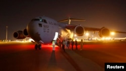 A U.S. Air Force plane carrying two Sudanese detainees released from the Guantanomo facility from Guantanamo in Cuba, arrives at Khartoum Airport early Dec. 19, 2013. 