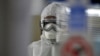 FILE - A technician tests swabs from patients for COVID-19 infection at the Central Health Laboratory in the Yemeni capital Sanaa, amid the novel coronavirus pandemic, April 11, 2020. 