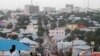 FILE - People walk along a street in Mogadishu, Sept. 28, 2013. 