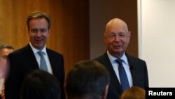 Klaus Schwab, founder and Executive Chairman of the World Economic Forum (WEF), and WEF President Borge Brende arrive for a news conference ahead of the Davos annual meeting in Cologny near Geneva, Switzerland, Jan. 14, 2020.