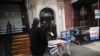 Funeral director Tom Cheeseman, center, and a colleague make a house call to collect a body, April 3, 2020, in the Brooklyn borough of New York. 