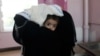 A woman carries a child at the malnutrition ward of al-Sabeen hospital in Sanaa, Yemen, Sept.11, 2018. 