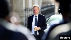 FILE - Britain's Secretary of State for Digital, Culture, Media and Sport Oliver Dowden arrives for a cabinet meeting, at Downing Street in London, Britain, July 21, 2020. 