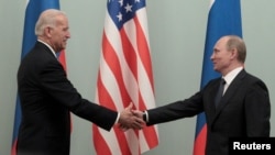 Joe Biden, alors vice-président des États-Unis (à g.), serre la main de Vladimir Poutine, alors premier ministre de la Russie, lors de leur rencontre à Moscou le 10 mars 2011. Les deux hommes sont désormais présidents de leurs pays respectifs.
