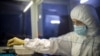 A staffer works with test systems for the diagnosis of coronavirus at the Krasnodar Center for Hygiene and Epidemiology lab in Krasnodar, Russia, Feb. 4, 2020. Russia has shut its land border with China and suspended most train traffic between them.