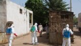 Health workers spray disinfectant at a mosque, in Bamako November 14, 2014. A local government official said the body of a Guinean imam, suspected of dying from the Ebola virus on October 27, was washed at the mosque before his funeral. Mali is tracing at